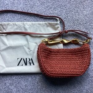 Zara straw bag with gold handle.
